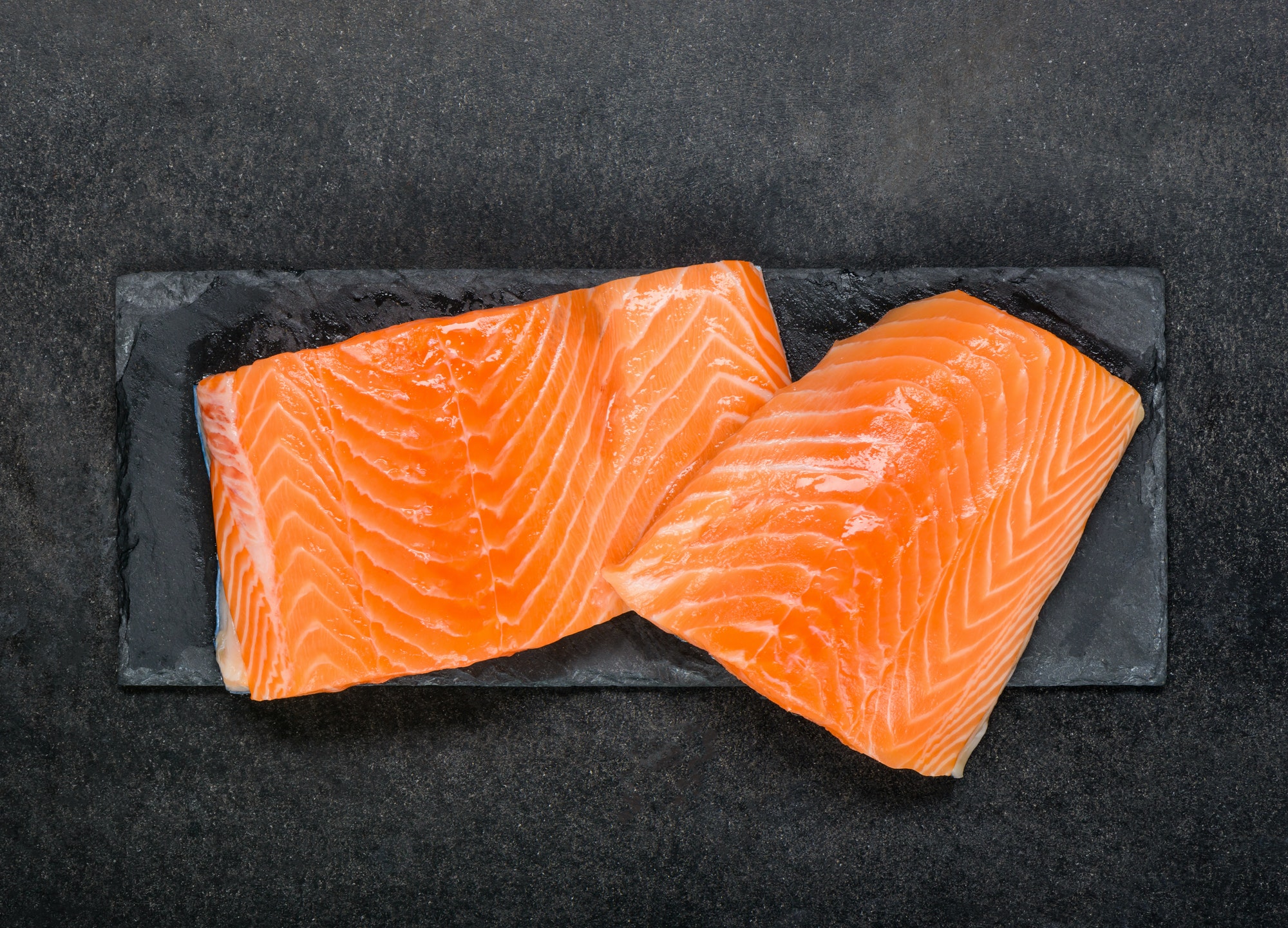 Red Salmon Fish Fillet Raw on black board